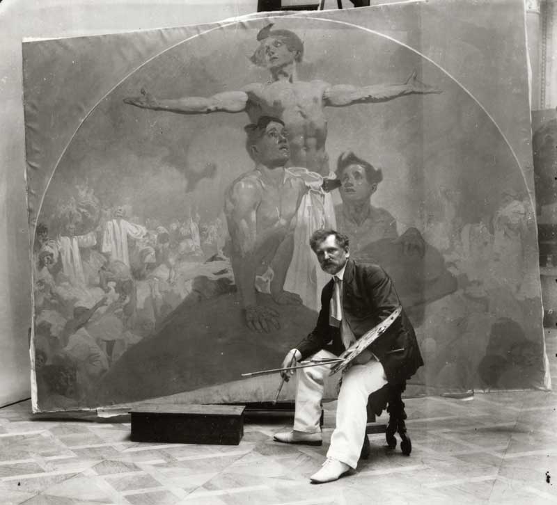 Amura,AmuraWorld,AmuraYachts, Autorretrato de Alphonse Mucha, 1910-1911, donde se le ve trabajando en un mural para el Salón del Alcalde, Casa Municipal de Praga. Negativo original de vidrio. Foto cortesía de Mucha Trust 2025.